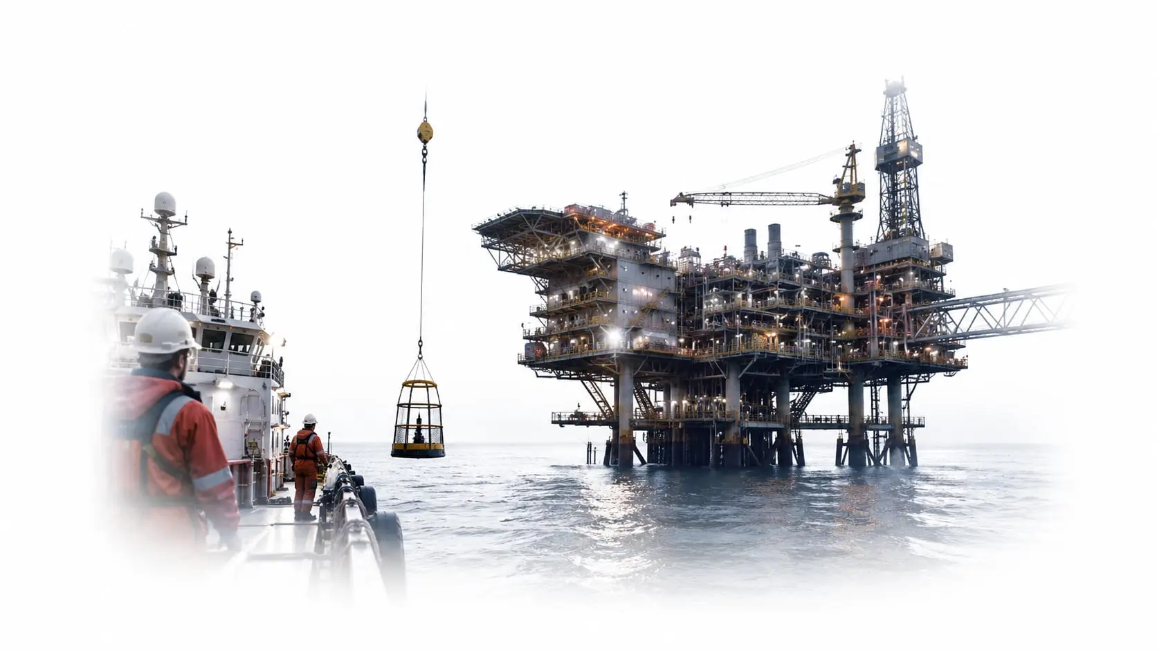 Offshore platform and support vessel in calm sea at dusk, deck lights on